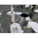 A continental silver miniature beaker, 4cm high and a three legged cauldron salt