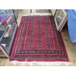 A Bokhara rug, the three rows of guls on a red field within a multiple border, 190 x 127 cm