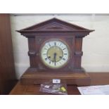 An Edwardian oak mantel clock, of architectural form, with cream chapter ring, the Junghans movement