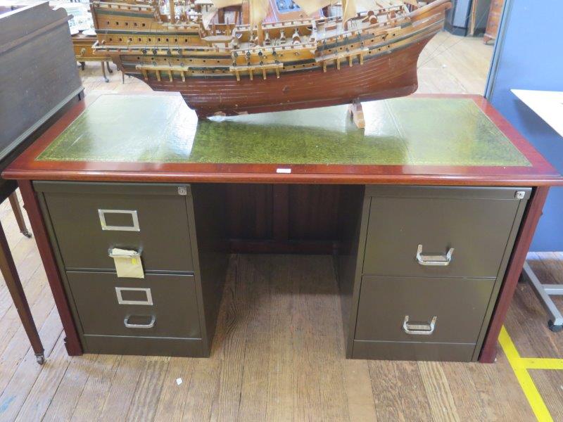 A reproduction leather top desk, with a pair of metal two drawer filing cabinets as pedestals, 157