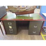 A reproduction leather top desk, with a pair of metal two drawer filing cabinets as pedestals, 157