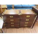 A pair of reproduction brass bound mahogany campaign style bedside cabinets, each with leather inset
