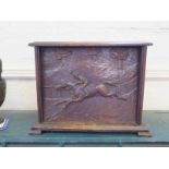 A carved oak box, the hinged lid over a panel front carved with a jockey on a race horse, 34 cm