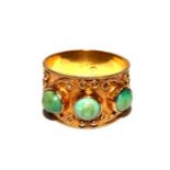 A Middle Eastern gold colour metal ring set with three turquoise