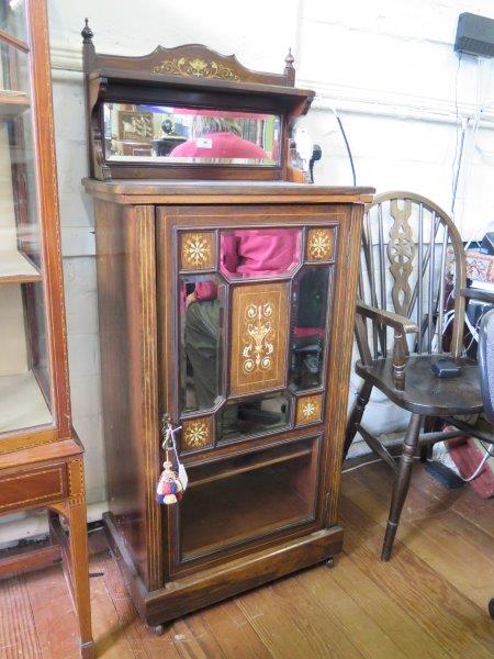 An Edwardian inlaid rosewood music cabinet, the raised mirrored back, over a mirrored, panelled