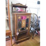 An Edwardian inlaid rosewood music cabinet, the raised mirrored back, over a mirrored, panelled