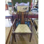 An Edwardian Art Nouveau design open armchair, the top rail and splat inlaid with foliate motifs, on