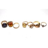 A collection of seven 9ct gold gem set rings to include a garnet set double headed snake ring, 38