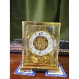 A Jaeger-LeCoultre brass cased Atmos clock, no. 372637, the white chapter ring with Arabic quarter