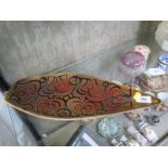 A Poole Pottery Aegean boat shape dish, the flowerhead motif in brown and orange, 44 cm long