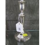 A single silver candle stick, of tapering form, engraved on the base, 17.5 cm high