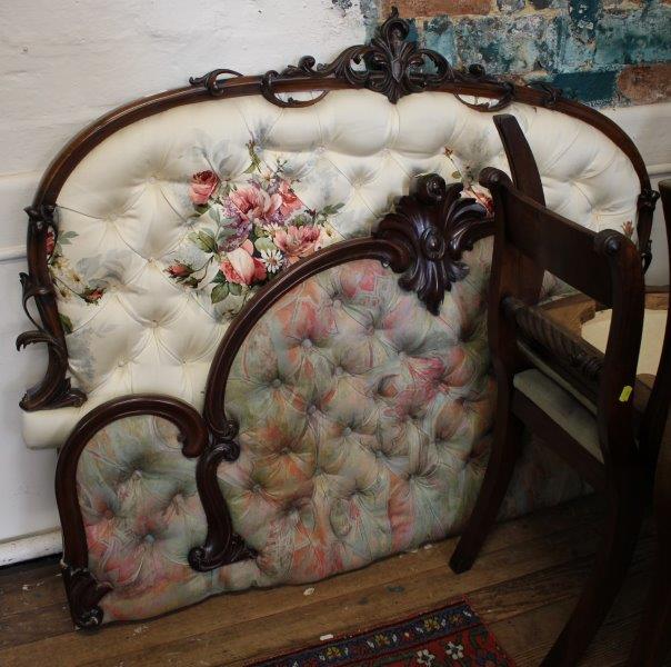 A Victorian mahogany bed head, the arched frame with foliate spray centre and button back