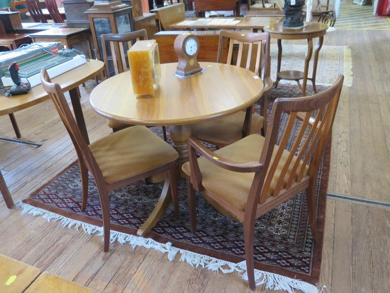 A set of four G-Plan dining chairs, including two carvers, with rail backs, and a circular teak