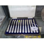 A box of twelve silver tea knives