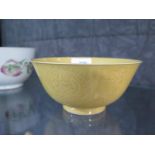 A Chinese yellow bowl, with six character mark, 14 cm diameter, restored and chipped