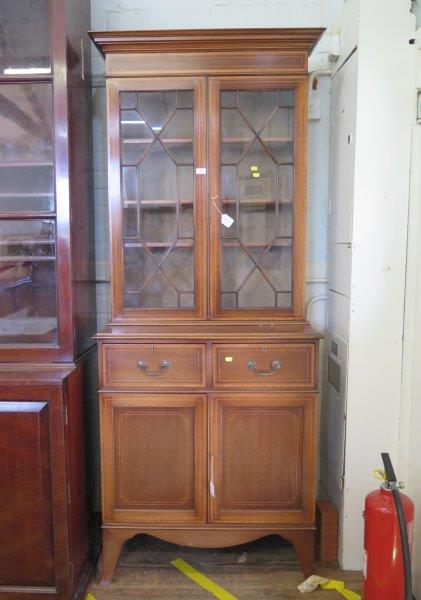 An Edwardian mahogany and crossbanded satinwood bookcase cabinet, the astragal glazed pair of