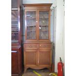 An Edwardian mahogany and crossbanded satinwood bookcase cabinet, the astragal glazed pair of