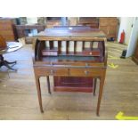 An Edwardian inlaid mahogany roll top desk, the scroll and urn inlaid top enclosing pigeon-holes and