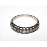 An eleven stone half eternity ring set in white colour metal