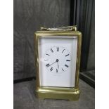 A brass carriage clock, inscribed Jules a Paris, with bevelled glass panels and inscribed enamel