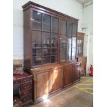 A 19th century mahogany bookcase cabinet, the cavetto moulded cornice over a large pair of glazed