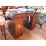 A Victorian walnut and stained beech pedestal desk, the leather inset top over three frieze