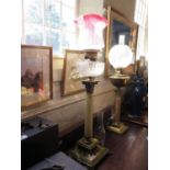 A late Victorian brass and onyx oil lamp, of column form with square open base, red glass shade,
