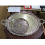 A large silver plated oval tray and a round plated tray