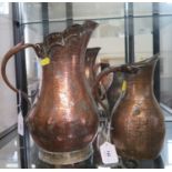 A Persian copper baluster jug, with allover foliate decoration, 33 cm high, and another similar