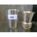 A French silver beaker with engine turned decoration, together with two plated beakers of