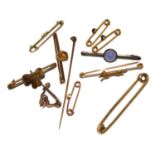 A collection of lace pins, some gold