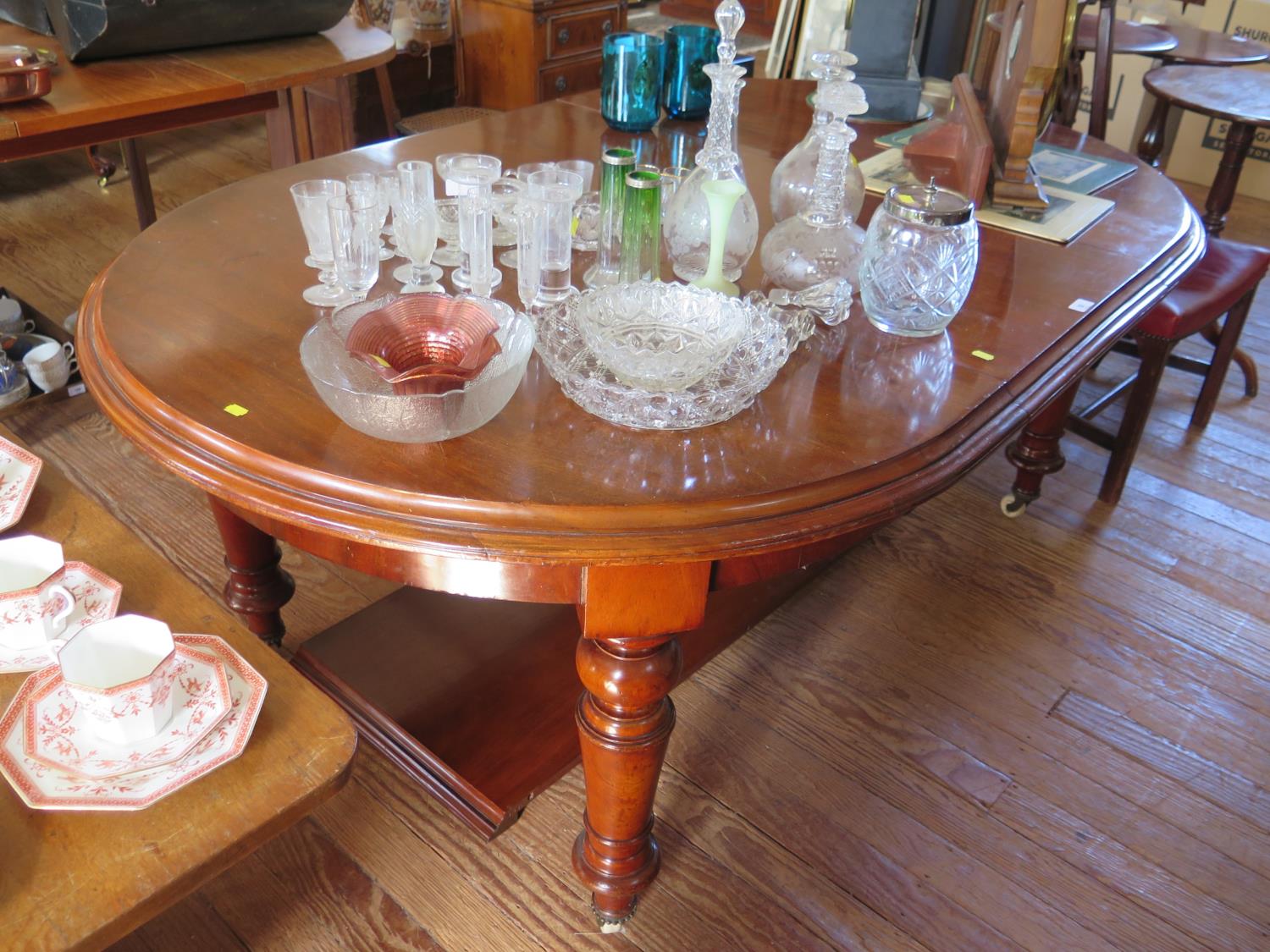 A Victorian mahogany extending dining table, with rounded ends and turned tapering legs on pot