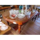 A Victorian mahogany extending dining table, with rounded ends and turned tapering legs on pot