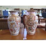A pair of Japanese Satsuma vases, depicting elders with two children, 31 cm high (2)