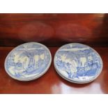 A set of four Chinese blue and white plates, each depicting figures in a room and gardens, 24.5 cm