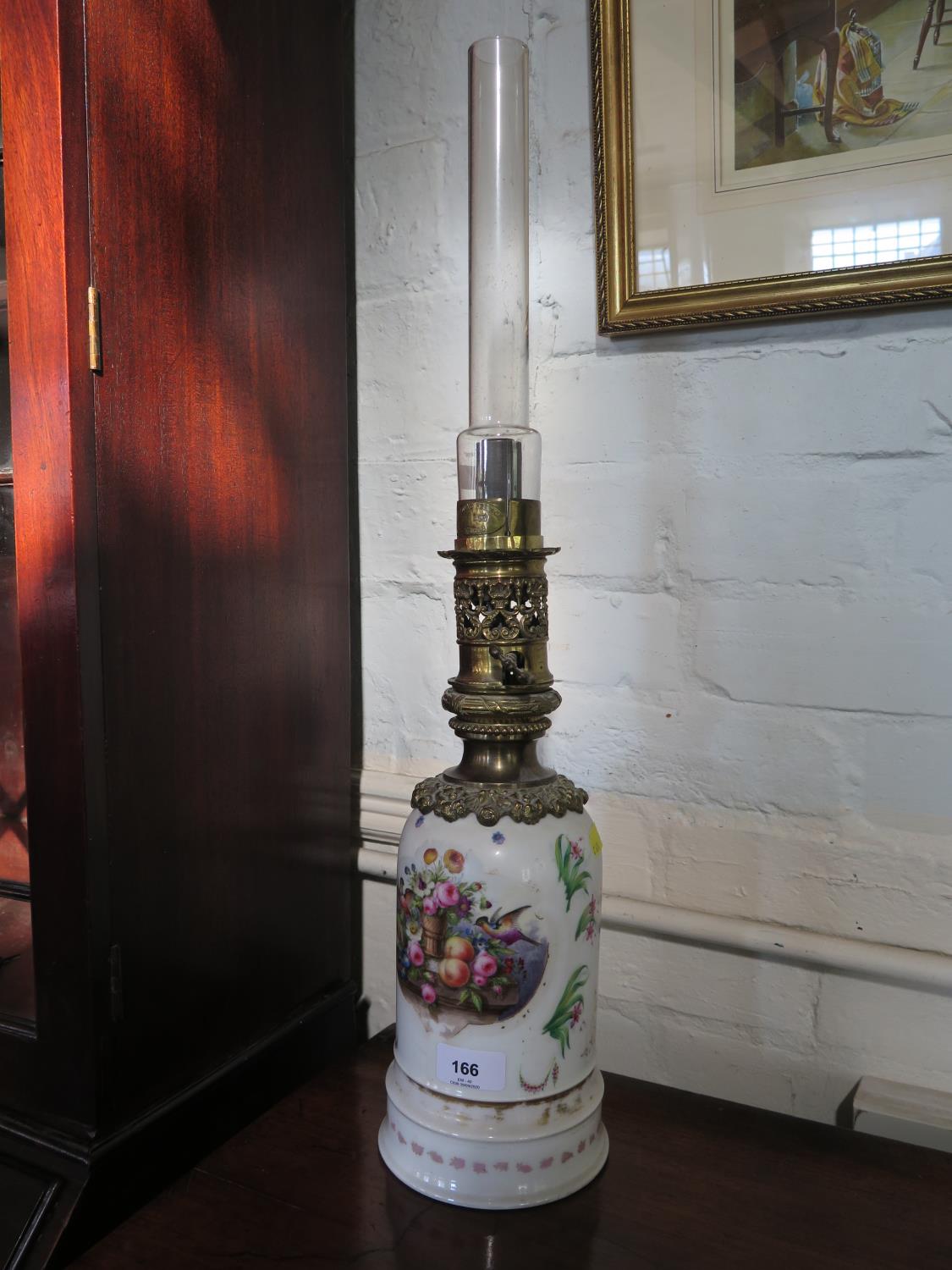 A late 19th century French porcelain oil lamp, labelled Thomas Pearce & Son, painted with birds,