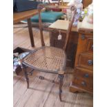 A Victorian walnut bedroom chair with cane seat