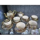 A Japanese Satsuma coffee service, depicting figures in landscapes, with five cups and six saucers