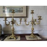 A pair of George III style giltmetal candelabra, in the rococo style, each with central holder and