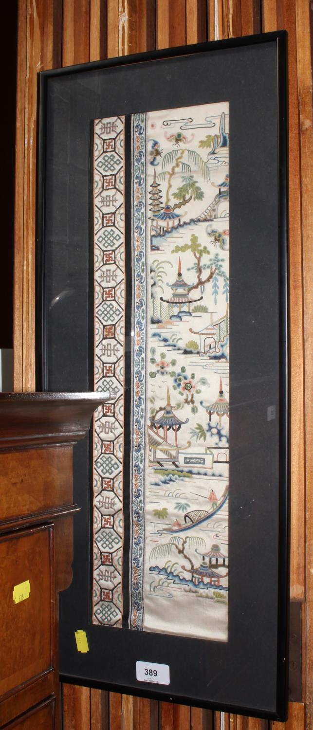A Chinese silk fragment panel, showing fishermen and pagodas, geometric side border, 53 x 15.5 cm