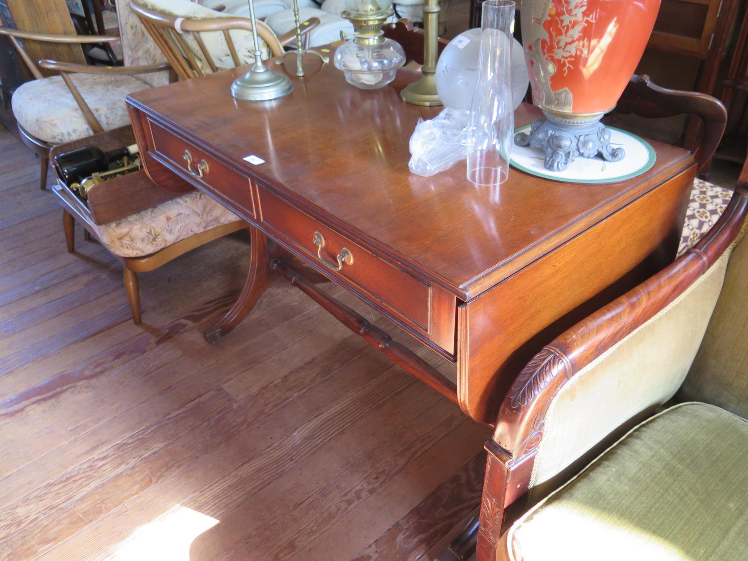 A Reprodux mahogany sofa table, with two frieze drawers on outsplayed legs joined by a pole