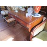 A Reprodux mahogany sofa table, with two frieze drawers on outsplayed legs joined by a pole