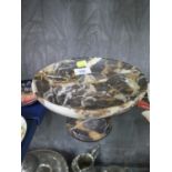 A variegated black marble tazza, the circular dish on a turned pedestal, 20 cm diameter, 12 cm high