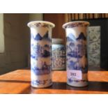 A pair of Chinese blue and white cylindrical vases, depicting fishermen in landscapes, 15.5 cm high,