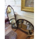 A mahogany oval wall mirror, the bevelled plate within a beaded and ribbon frame, 101 x 66 cm, and a