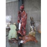 A Chinese carved redwood figure of a harty fisherman, a jadite foo dog, a carved wood tortoise, a