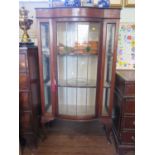 A boxwood lined mahogany display cabinet, with lead glazed bowfront door on cabriole legs, later