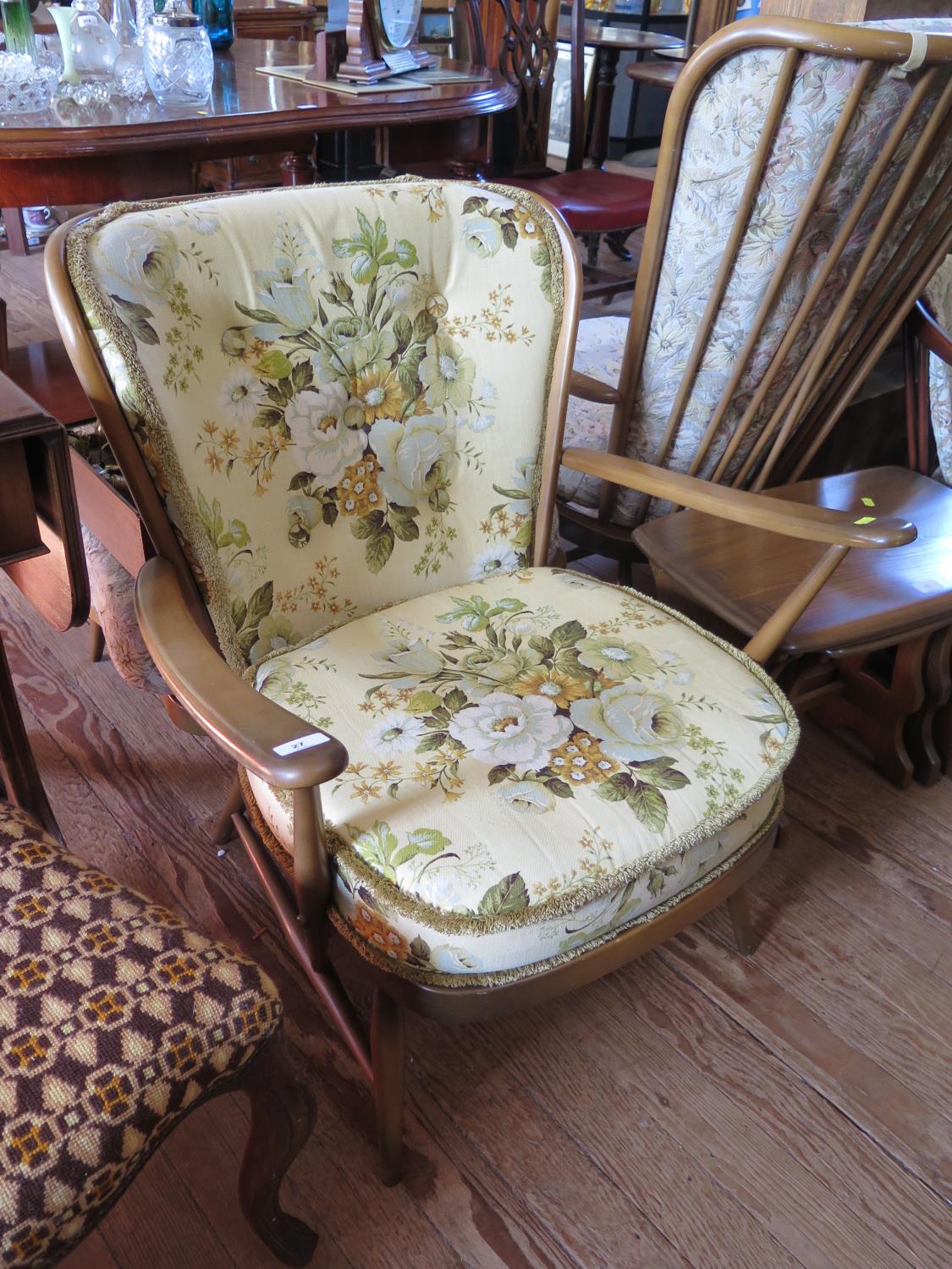 An Ercol ash spindle back armchair, labelled under the seat