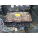 A trinket or jewellery box with applied silver decorated floral panels to top and all round sides,