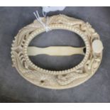 An ivory oval photograph frame, from circa 1920 decorated with dragons, 10 cm high